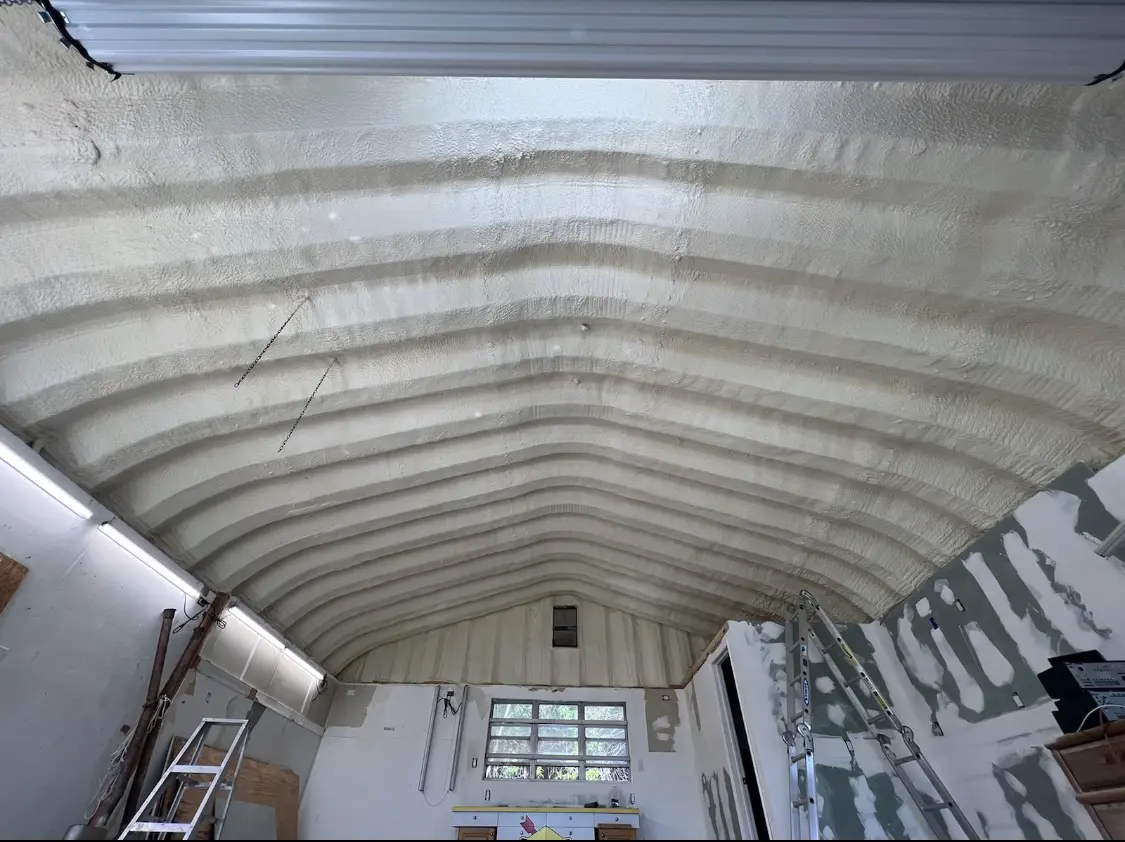 Spray polyurethane foam applied to the underside of a metal roof deck in Oxford